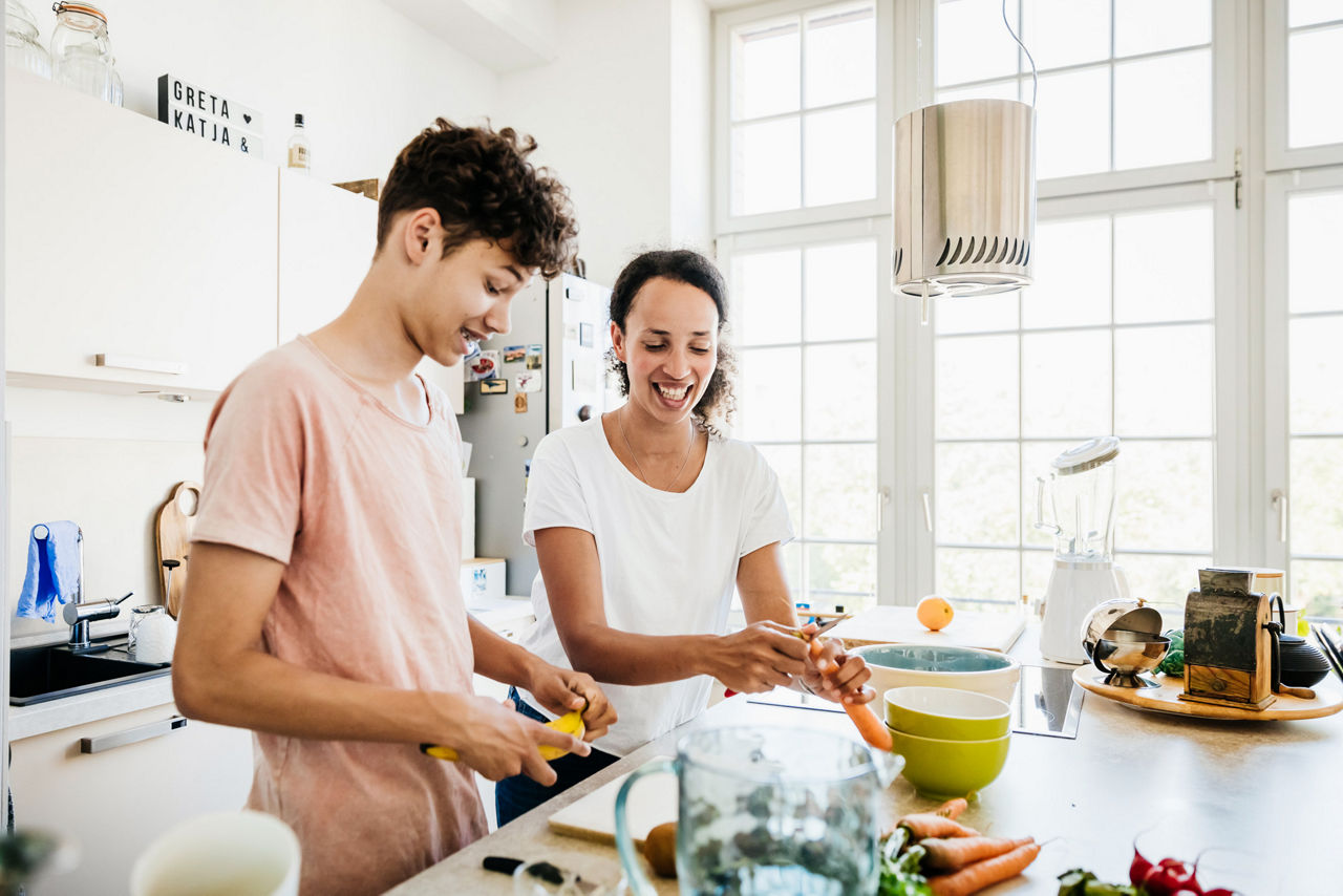 Mother and son preparing a shake in their kitchen