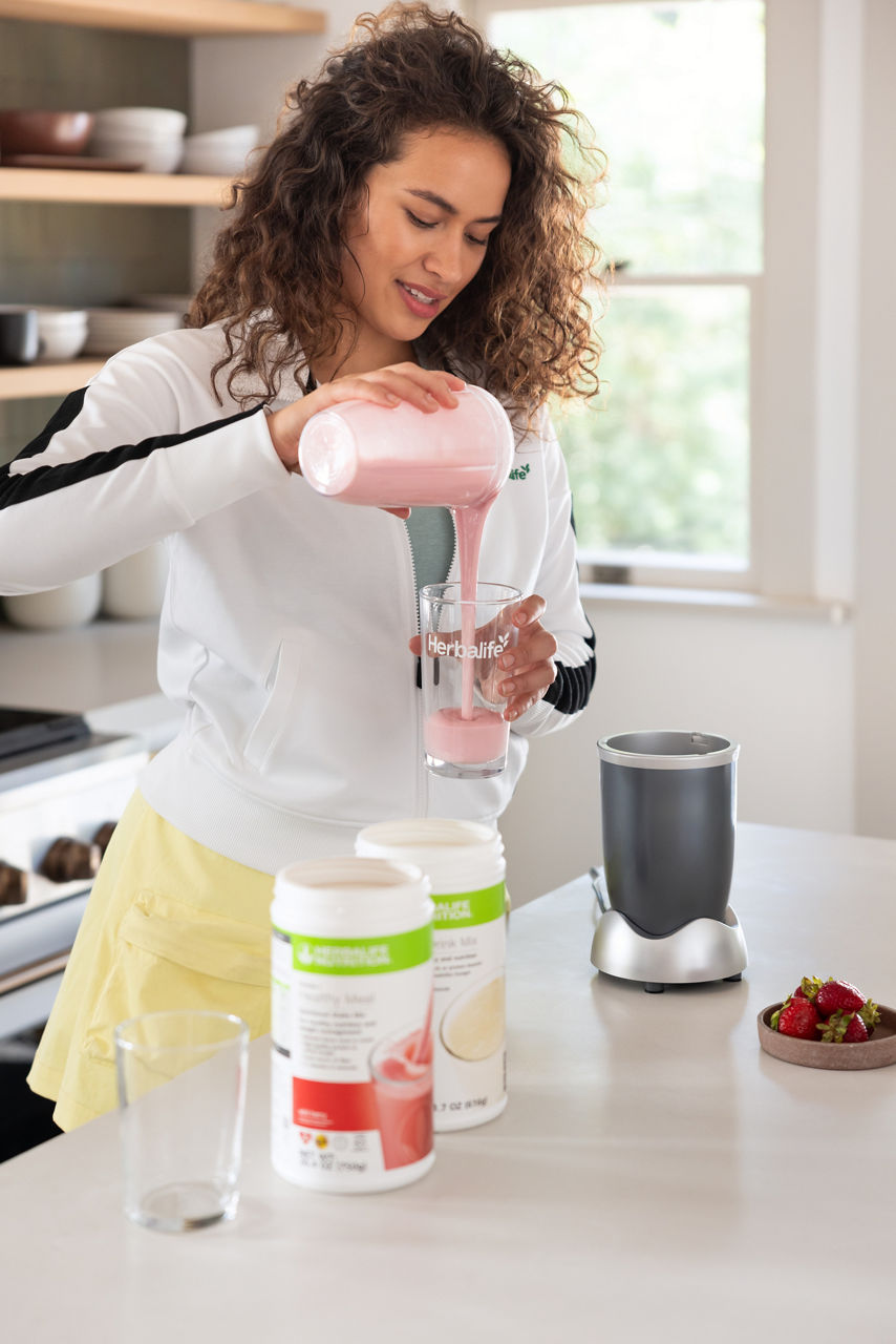 woman pouring shake